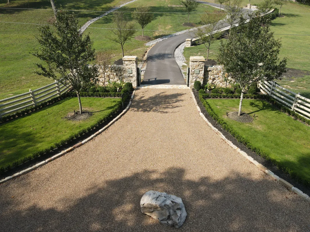 Finished gravel estate driveway with stone entrance columns