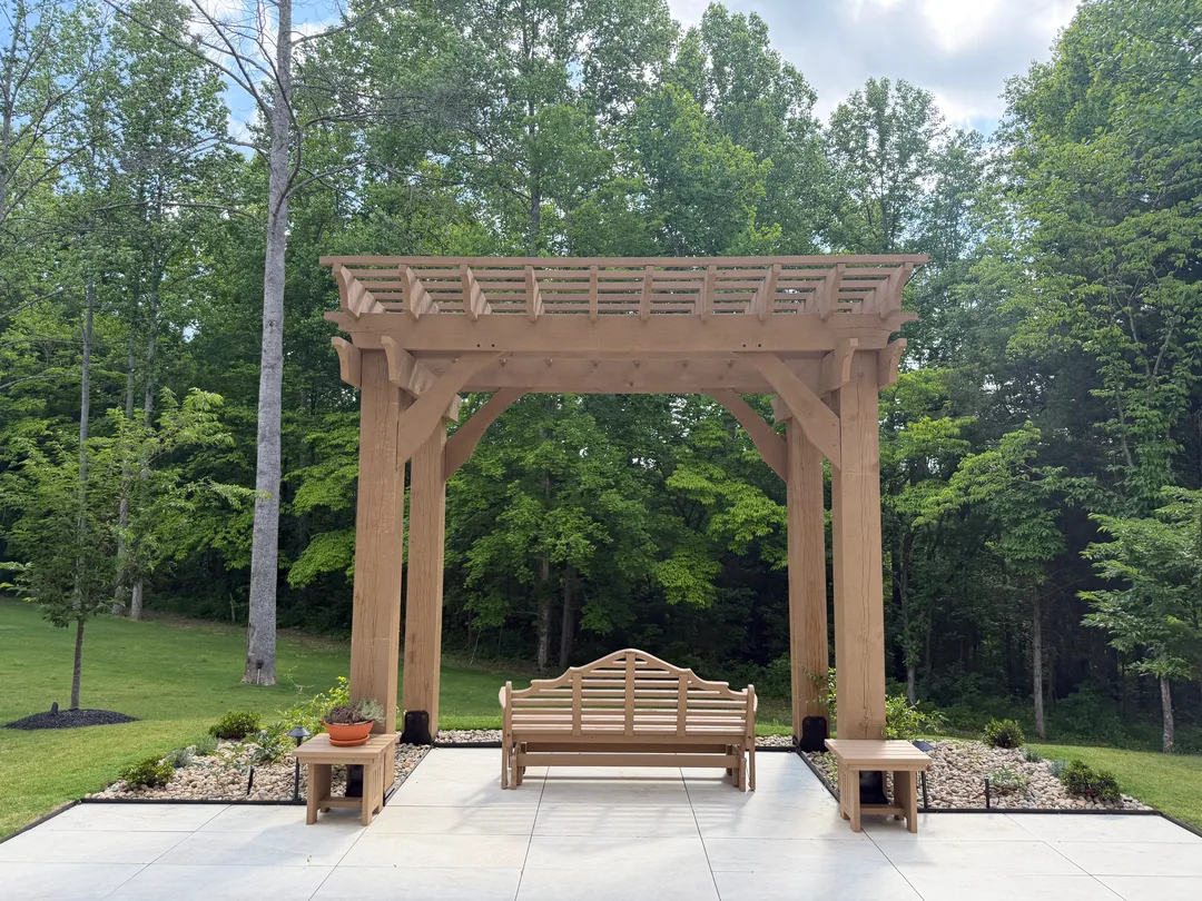 Garden pergola with bench and finished planting beds